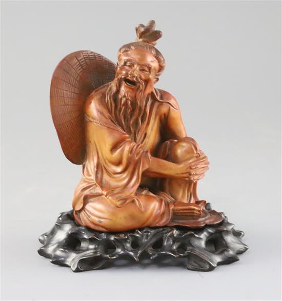 A Chinese boxwood seated figure of a fisherman, with hongmu stand, c.1900, H.15cm